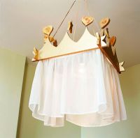 Close-up of hanging lamp with curtain