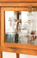 Close-up of display cabinet with a collection of decanters 
