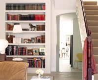 Stairs in living room with bookcase