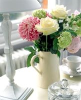 Jug of flowers on table