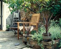 Wooden chair on patio in small garden