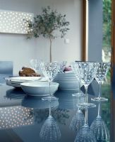 Glasses and bowls on glass dining table