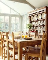 Dining room with wooden table, chairs and dresser