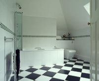 Bathroom with bath and checked tile floor