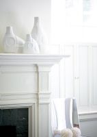 Modern white vases on mantelpiece