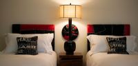 Twin beds in bedroom with lamp
