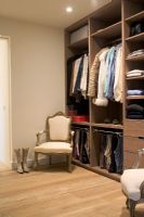 Modern walk-in closet with armchairs