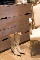 Dressing room closet with ladies cowboy boots and armchair