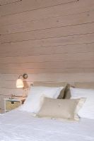 Modern bedroom with natural wood panelling