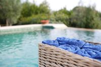 Basket of towels beside swimming pool