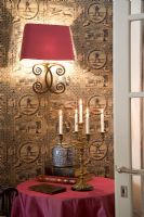 Wall mounted lamp and candelabra on table