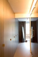 Wardrobe lined corridor to modern bedroom 