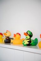 Colourful rubber ducks on shelf, detail