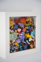 Toys in a wall mounted box frame, detail 