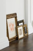 Picture frames leaning against wall