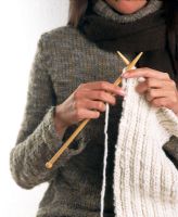 Woman in a sweater knitting