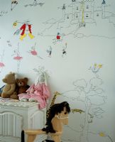 Child's room with a drawn wall mural