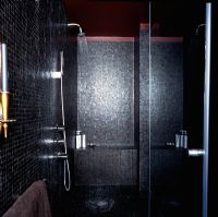 Black tiled shower in a modern bathroom
