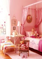Young girl in her bedroom with soft toys