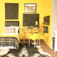 Yellow bedroom with bed and side table with chair