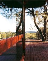 Large wooden patio reflected in a sliding glass door
