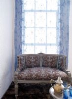 Vintage sofa in front of a curtained window