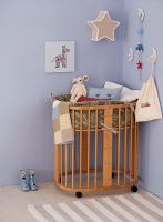 Blue room with a baby's crib 