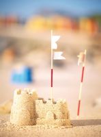 Two flags on sand castle