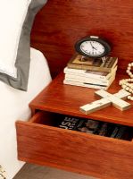 Books clock and crucifix with beads and open drawer