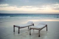 Two daybeds on a beach