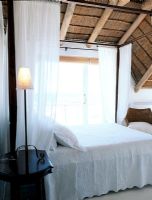 Modern African bedroom with a thatched roof