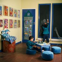 Two boys drawing in a play room