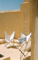Three butterfly chairs on a patio