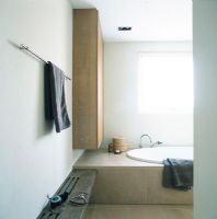Bathroom with bathtub and towel on rail
