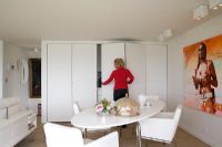 Woman opening concealed kitchen doors 