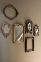 Display of frames and mirrors on wall