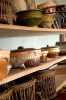 Ceramic pots and baskets on kitchens shelves