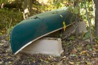 Upturned canoe in country garden detail 