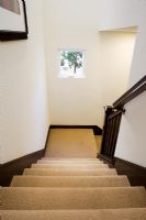 Traditional White Stairwell with Beige Carpeting