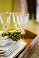 Tray with Crystal Glasses, White Dishes, and Green Napkins