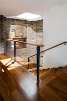 Hardwood Stairwell with Stone Tile Walls