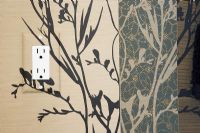 Detail of electrical socket on a wallpapered wall