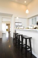 Three bar stools in a contemporary kitchen