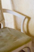 Detail of worn chair with cushion