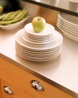 Green apple on stack of plates