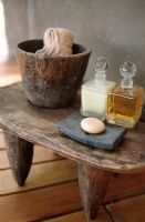 Oil bottles and soap on wooden table