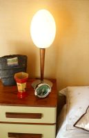Bedside table with a lamp and alarm clock