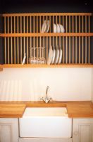 View of sink and plates in rack