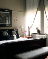 Interior of modern bedroom with bed and cat