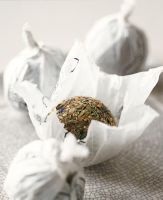 Dried ball of tea leaves in tissue paper